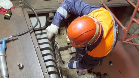 A worker in a hard hat repairs a mechanism Stock Footage 226715268