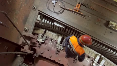 A worker in a hard hat repairs a mechanism Stock Footage 226715568