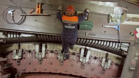 A worker in a hard hat repairs a mechanism Stock Footage 226715600