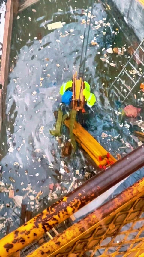Worker in Harsh Conditions Fixing Timber in Icy Water Stock Footage 307436901