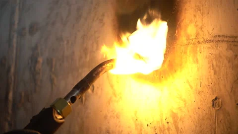 Worker Heating and Scraping Concrete Hole with Blowtorch (With Audio) Vídeos de archivo 334948169