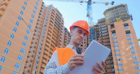Worker in helmet near the construction yard Stock Footage 116030320