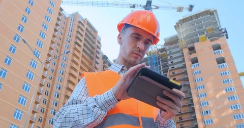 Worker in helmet near the construction yard Stock Footage 116031300