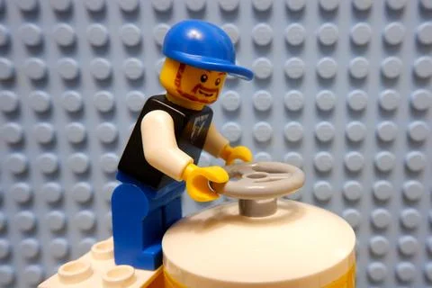 A worker in a helmet opens the valve Stock Photos