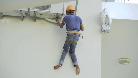 Worker in helmet repairs an air conditioner Stock Footage 84880688