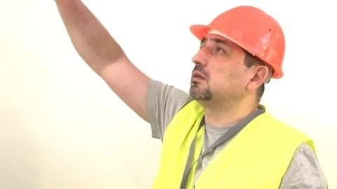 The worker in the helmet shows the signal Down Stock Footage 93132837