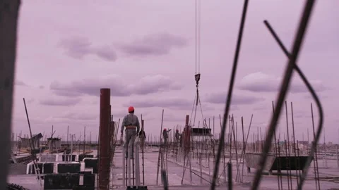 A worker in a helmet walks through the construction site Stock Footage 176419558