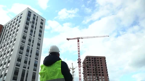 A worker in a helmet watching a construction site Stock Footage 166053214