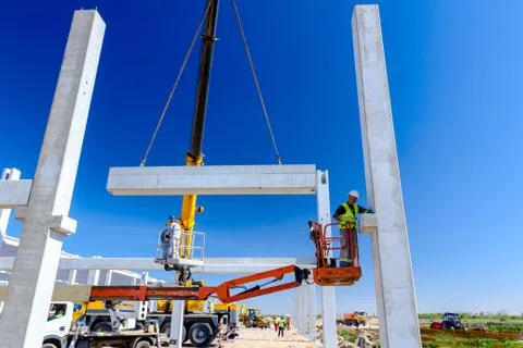 Worker is helping crane from cherry picker, keep balance and direction Stock Photos