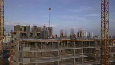 A worker on a high-rise building clogs the formwork for pouring concrete in the Stock Footage 156734666