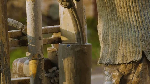The worker, with his bare hands, lowers the dirty hose into the pipe. Dirt stick Stock-Footage 122324616