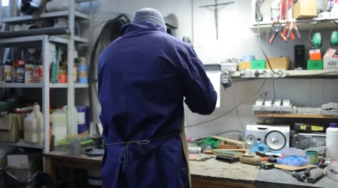 Worker in his shop, hammering Stock Footage 61263068