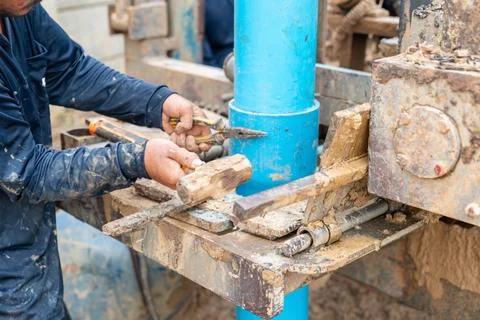 Worker hit nails pvc pipe connecting with hammer. Stock Photos