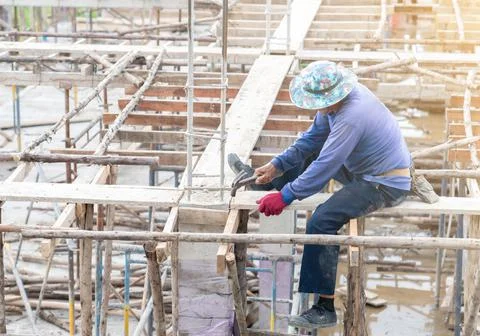 Worker hit nails on second floor for instruction formwork. Stock Photos