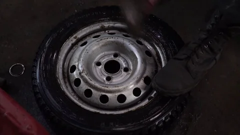 The worker hits the wheel with a hammer Stock Footage 84284354