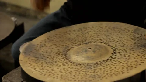 Worker hitting on a cymbal with hammer Close up Video stock 237622244