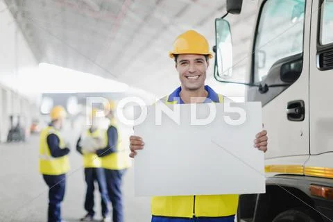Worker Holding Blank Card By Truck