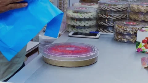 Worker holding blue plastic bag near stacked food containers Stock Footage 337481979