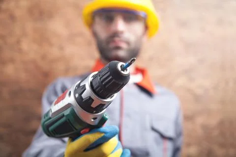 Worker holding cordless screwdriver. Construction tool Stock Photos