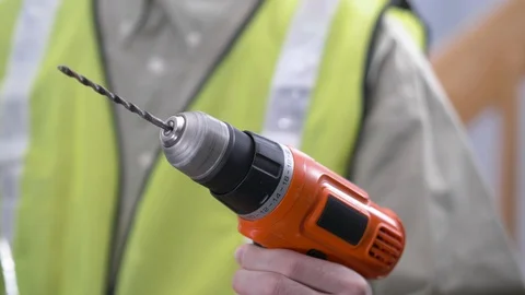 Worker Holding a Drill Closeup on The Spinning Bit Stock Footage 103779615