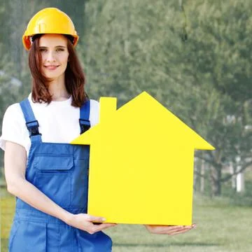 Worker holding house model Stock Photos