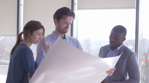 Worker holding a large sheet of paper thinking about economic results Stock-Footage 73866985