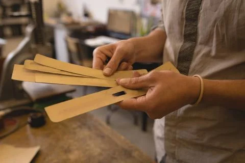 Worker holding leather sheet in workshop 写真素材