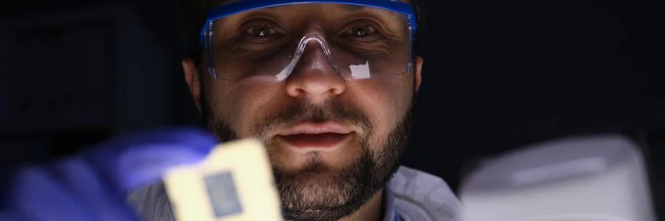 Worker holding microchip Stock Photos