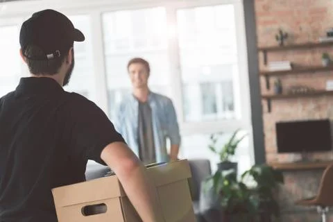 Worker holding post box in arm Foto stock