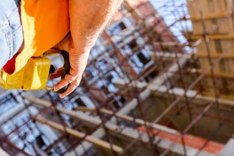 Worker is holding remote, wireless, control for overhead crane at building si Stock Photos