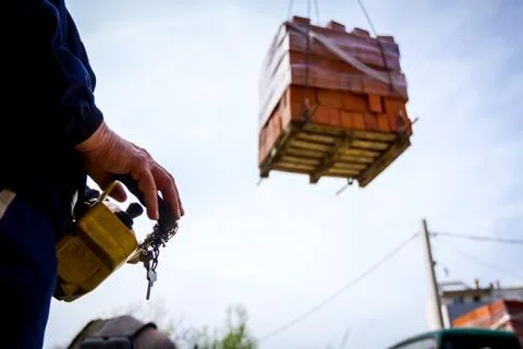 Worker is holding remote, wireless, control for overhead crane Stock Photos