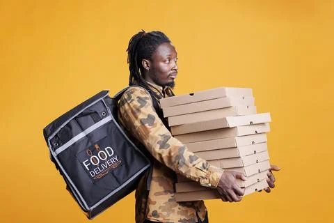 Worker holding stack with pizza cardboxes Stock-Fotos