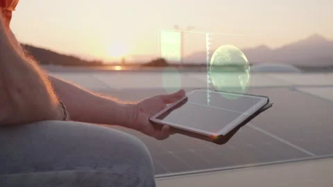 Worker holding tablet with indicator hologram rooftop solar panel array Stock Footage 278470159