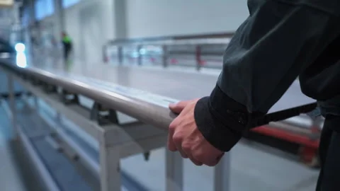 Worker holds long laminated windowsill transported by conveyor Stock Footage 304395343