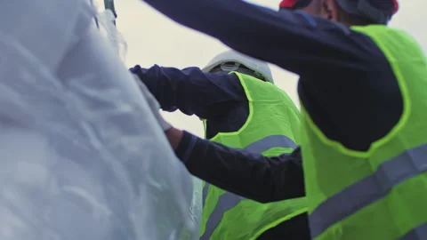 Worker holds star while colleague tries to unpack for installing Vídeo Stock 258468715