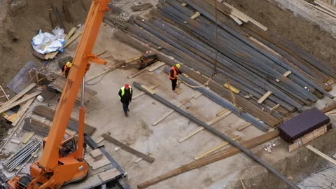 Worker hooking steel bar to a crane rope at the construction site Stock Footage 236473486