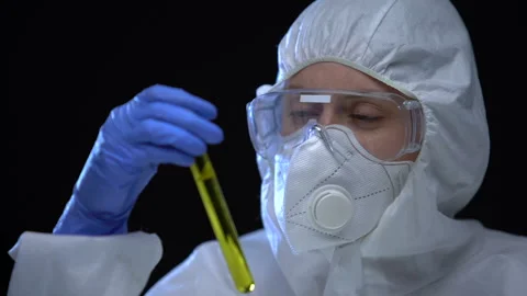 Worker of illegal fuel lab holding in hands test tube with flammable additive Stock Footage 115417389