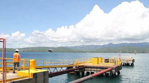 Worker on Industrial Area Dock for ship discharge of chemicals Stock Footage 33757086