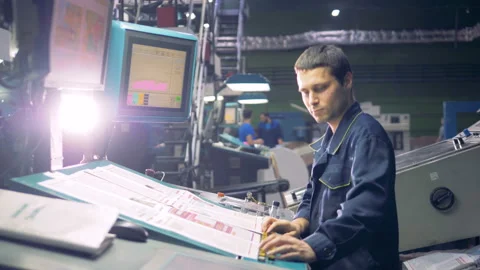 Worker at industrial computerized machine operating with factory line. Stock Footage 87245952
