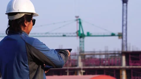 Worker at industrial plant typing on a tablet  Stock Footage 147605014