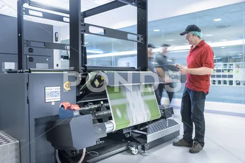 Worker With Ink Jet Printer In Food Packaging Printing Factory