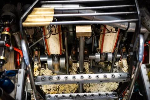 Worker insert a coal inside the engine of coaled power steam ship Stock Photos
