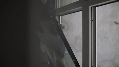 Worker inserting double glazed window unit during installation Stock Footage 323871383