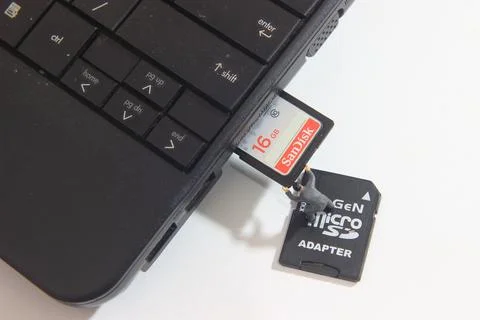 Worker inserting Sandisk 16 GB SD Card into Notebook Slot Stock Photos