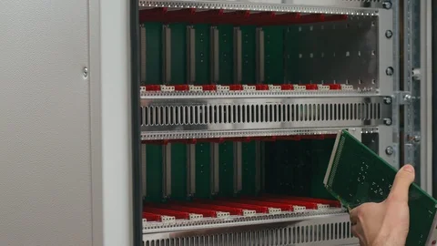Worker inserts equipment into telecommunications server rack Stock Footage 95607567