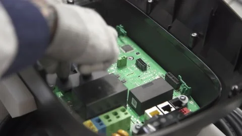 Worker inserts the part and passes the product further along the conveyor Stock Footage 211817996