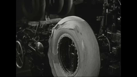 Worker inserts rubber on whitewall tire in automobile factory - 1939 Stock Footage 103598100