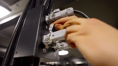 Worker Inserts Wire, Square Plug into Power Outlet Video stock 262111574