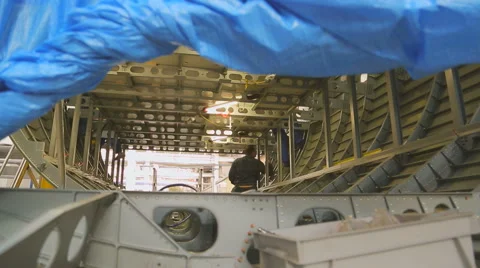 Worker inside fuselage mounts to luggage compartment Video stock 66953635