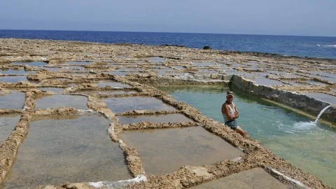 Worker inside salt pans in Malta Mediterranean sea Stock Footage 108390393